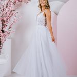 G295 Sweet lace blossoms and trailing vines cover the bodice of this amazing A-line gown