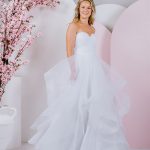 G296 All frills and ruffles, a full tulle skirt pairs perfectly with the strapless sweetheart neckline