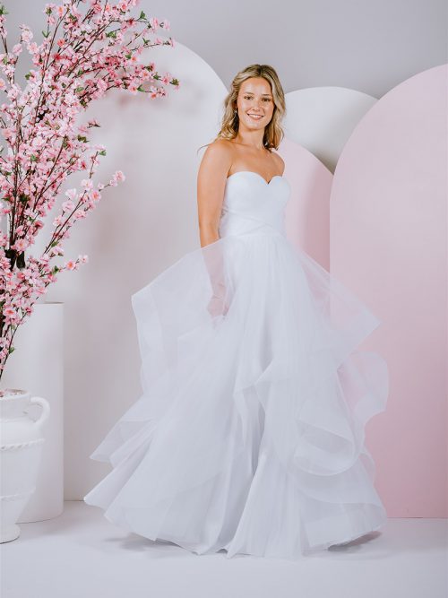 G296 All frills and ruffles, a full tulle skirt pairs perfectly with the strapless sweetheart neckline